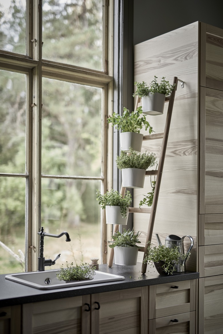 kitchen window idea with wooden plant stand in kitchen window