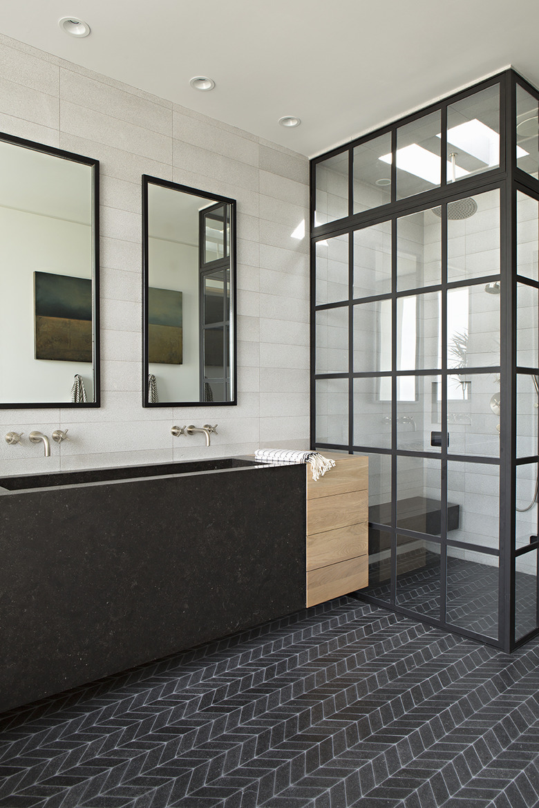 modern industrial bathroom with chevron mosaic bathroom floor tile and trough sink