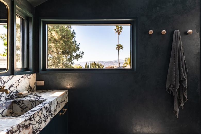 A marble integrated sink in a black bathroom