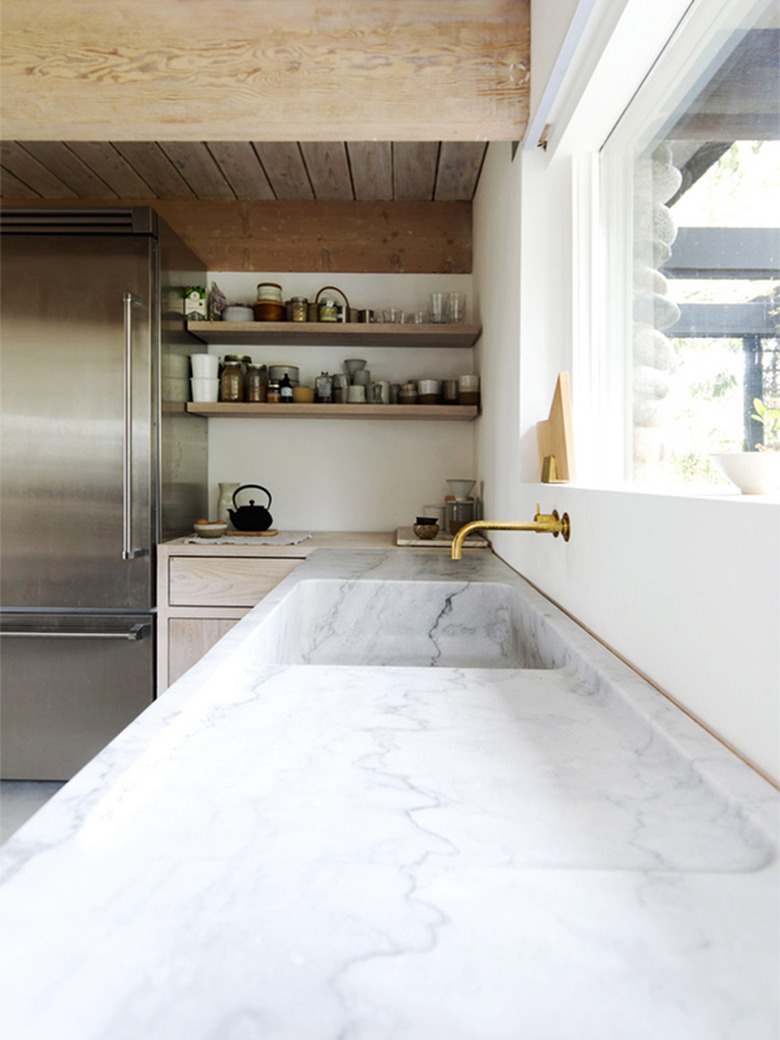 rustic farmhouse kitchen with marble countertop and integrated sink