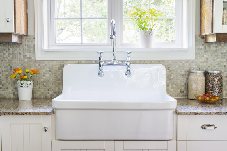 Country kitchen counter with tile backsplash and deep sink