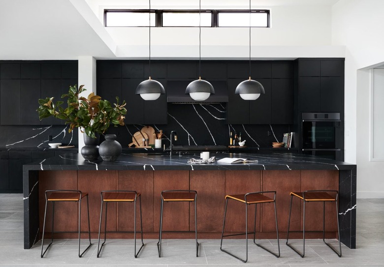 white kitchen with black cabinets and black marble counters