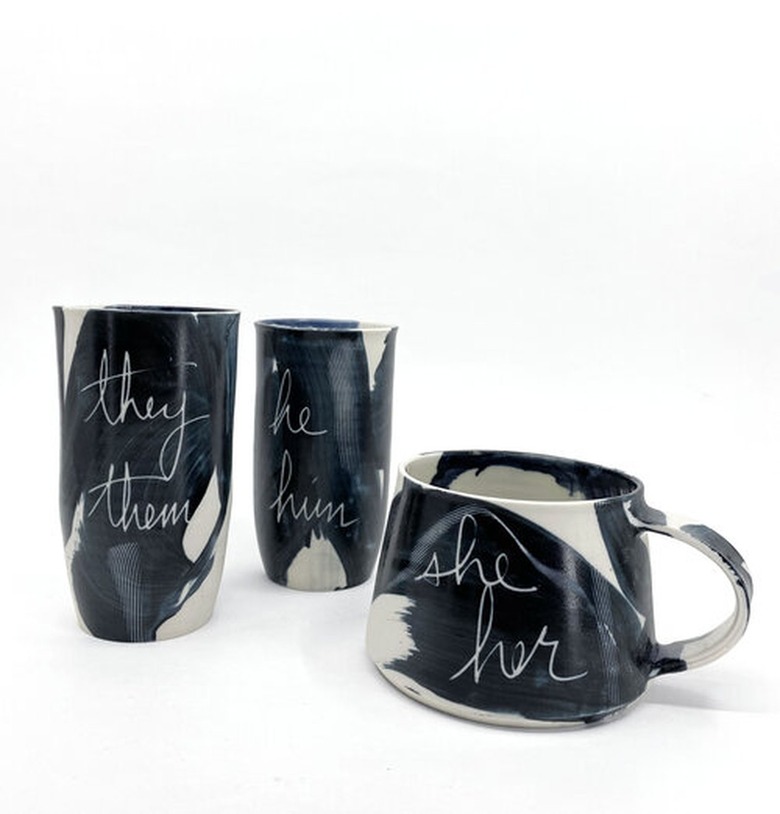 black and white mugs with writing that says 