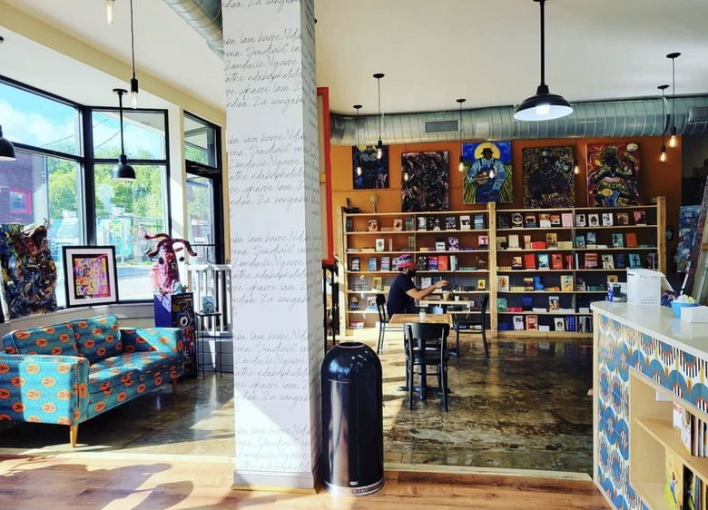 Interior of book café space with shelves and a bright couch