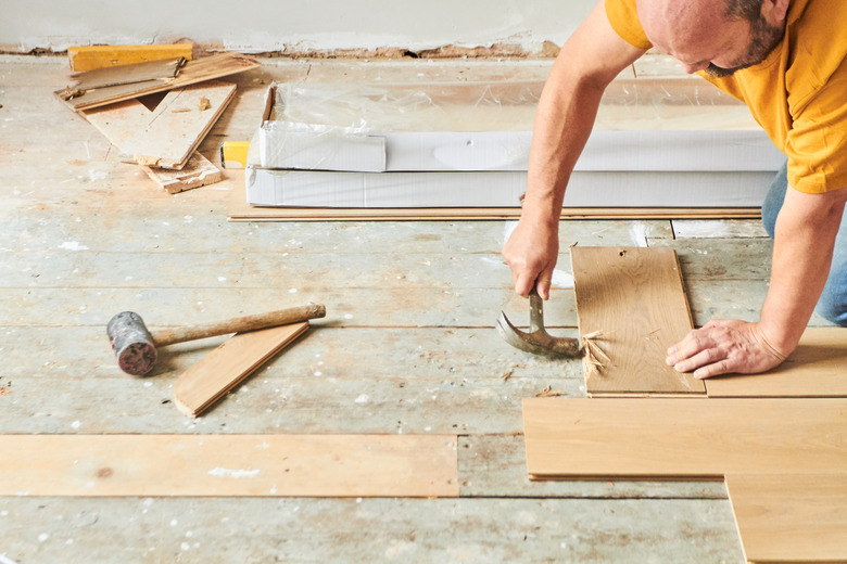 Carpenter laying new wood flooring