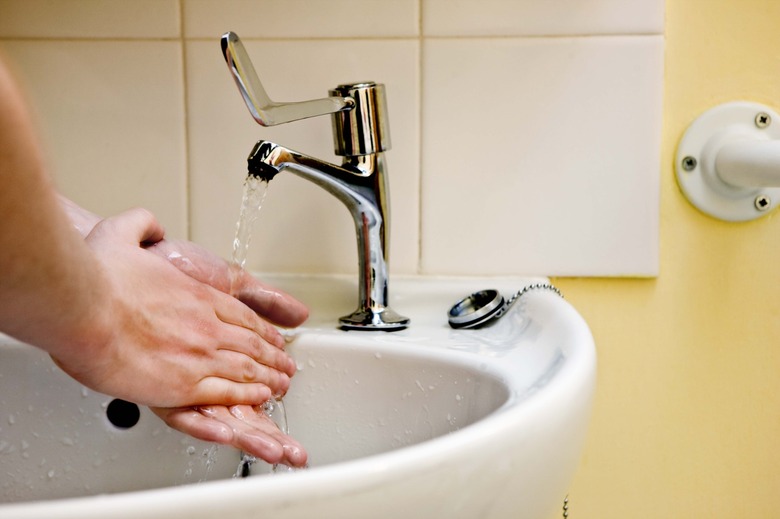 Woman washing hands in sink