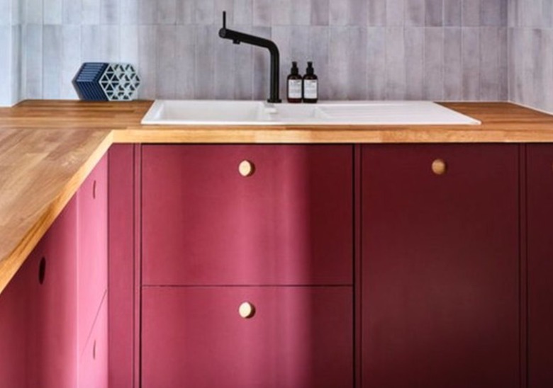 Red kitchen cabinets with wood counters