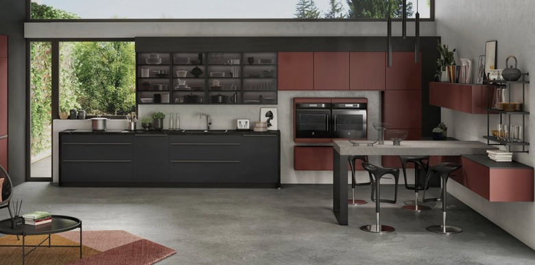 Black and rust kitchen with concrete floors