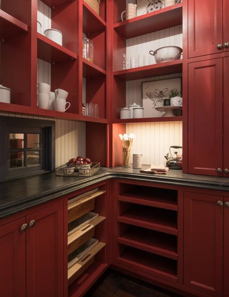 Kitchen with dark red cabinets and shelves