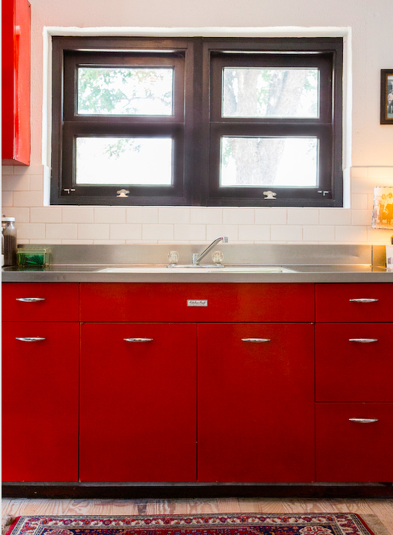 Red kitchen cabinets with stainless steel countertops