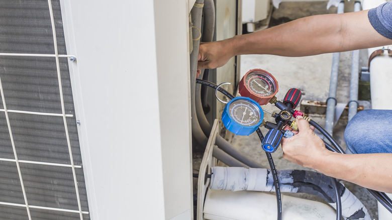 technician checks the operation of the air conditioner.