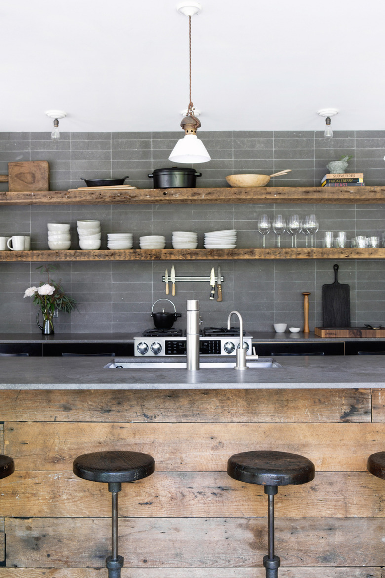 Industrial kitchen island idea with gray backsplash and gray countertops and open shelving