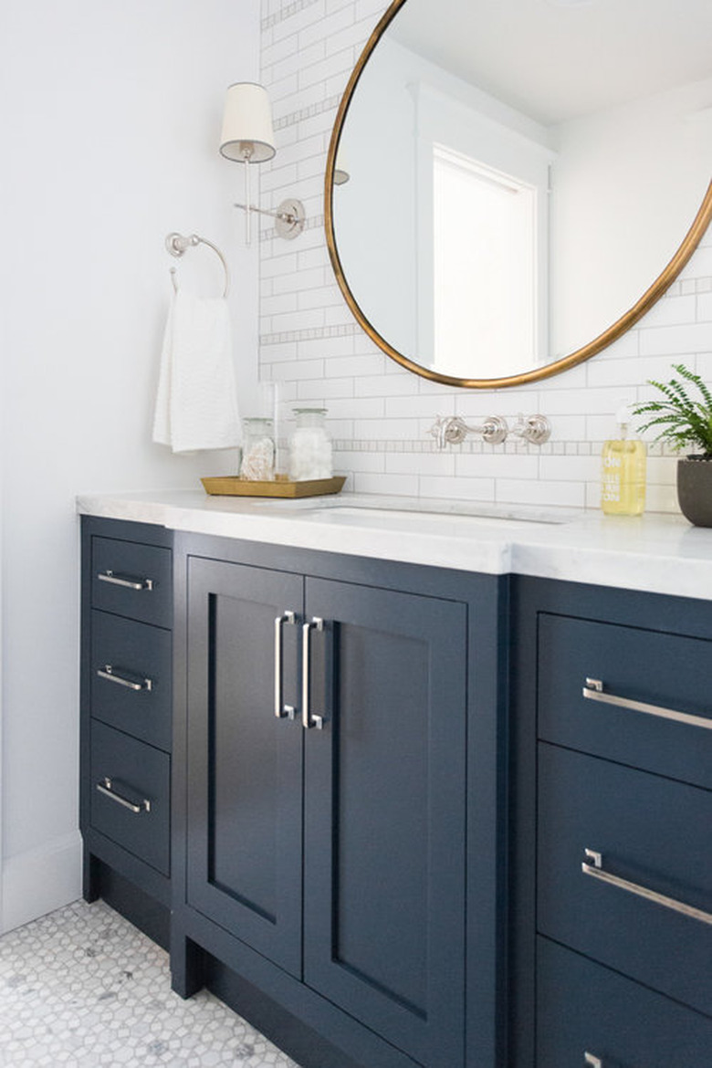 bathroom idea with blue cabinets and white countertop