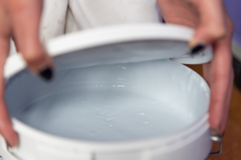 Woman hands opening paint can