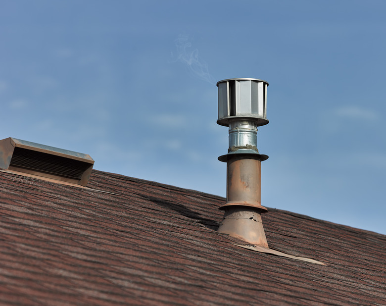 Metal roof vents on a composite shingled roof.