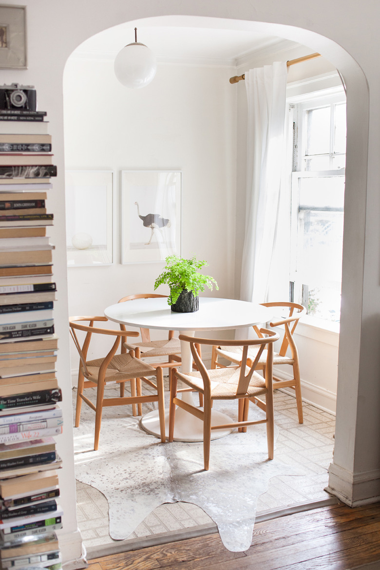 ivory cowhide rug for kitchen floor in eat-in kitchen with tulip table and wishbone chairs