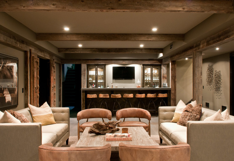 rustic basement ideas with beams and leather chairs