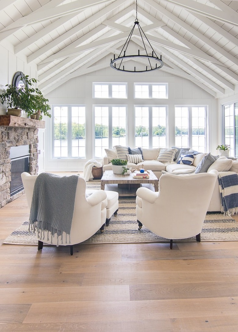 rustic beach decor in living room with white chairs and white sectional