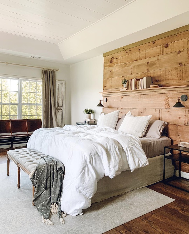 rustic bedroom lighting ideas with DIY wood feature headboard with black wall sconces