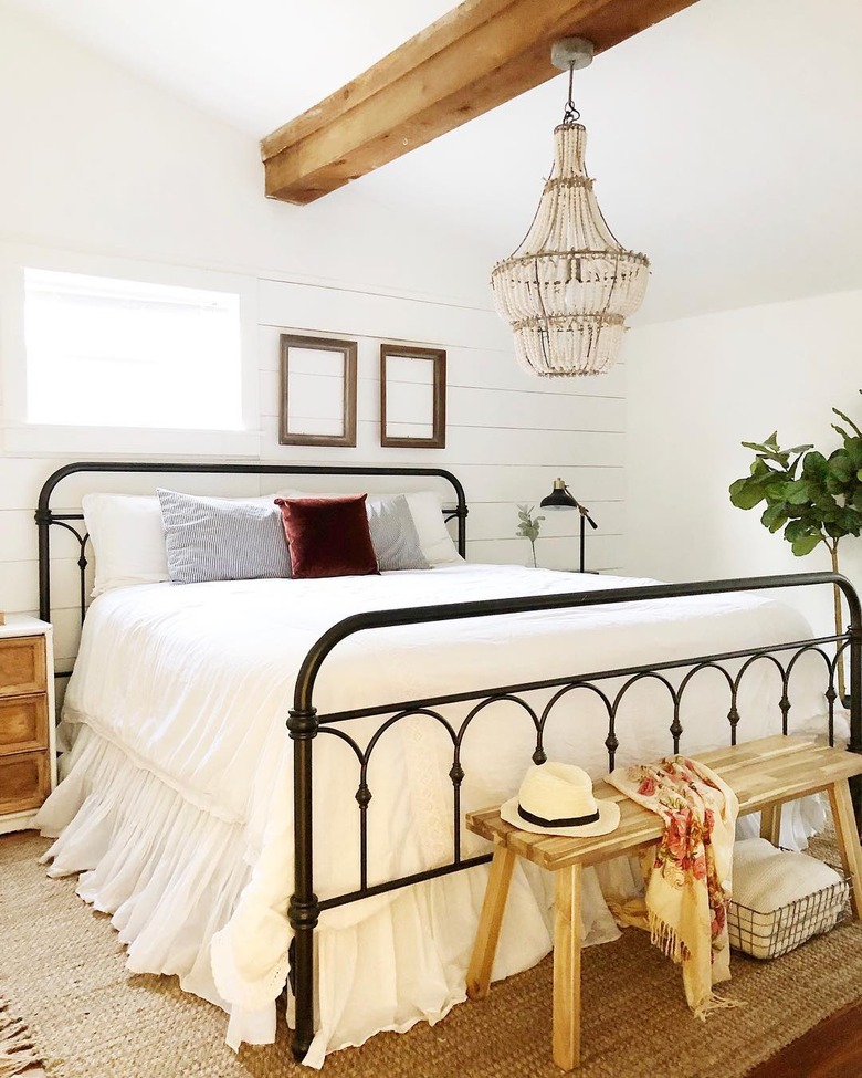 rustic bedroom lighting idea with beaded chandelier with black metal bed in rustic bedroom