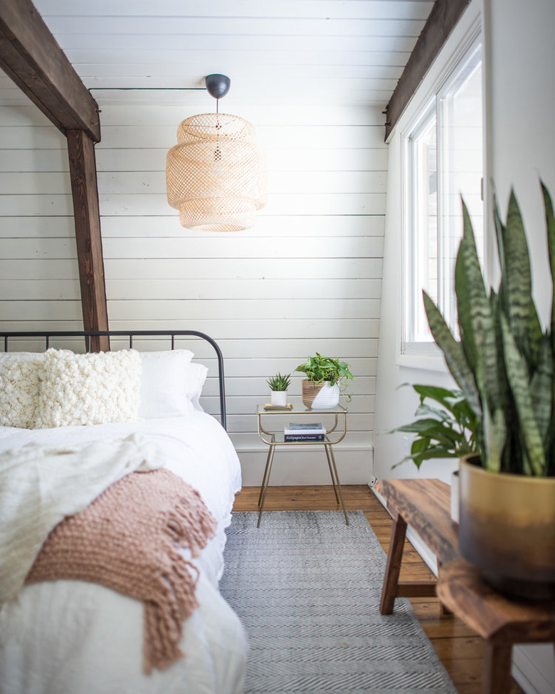 rustic bedroom lighting idea with IKEA rattan pendant light hanging from ceiling with shiplap walls