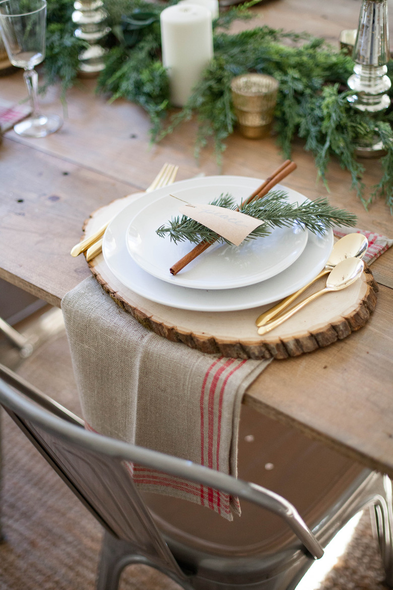 Rustic Christmas decorations on table with wood slices and tea towels