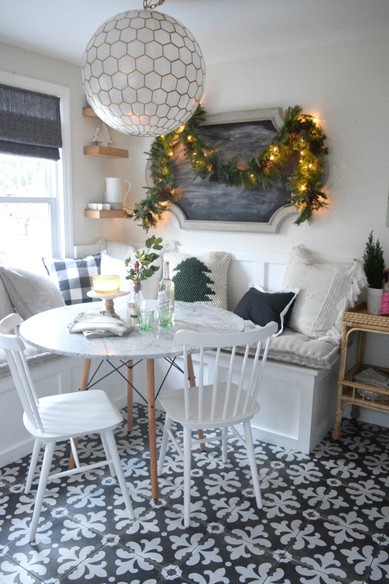 Rustic Christmas decorations in breakfast nook with throw pillows and garland