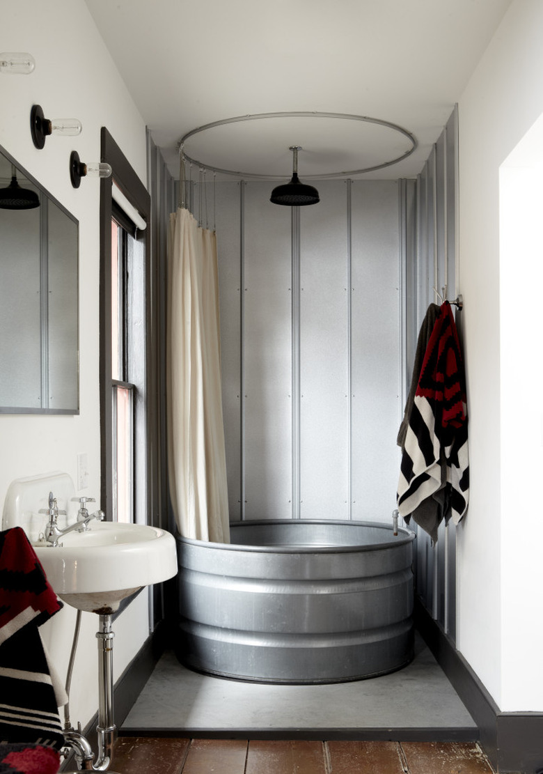 rustic industrial decor in bathroom with metal tub