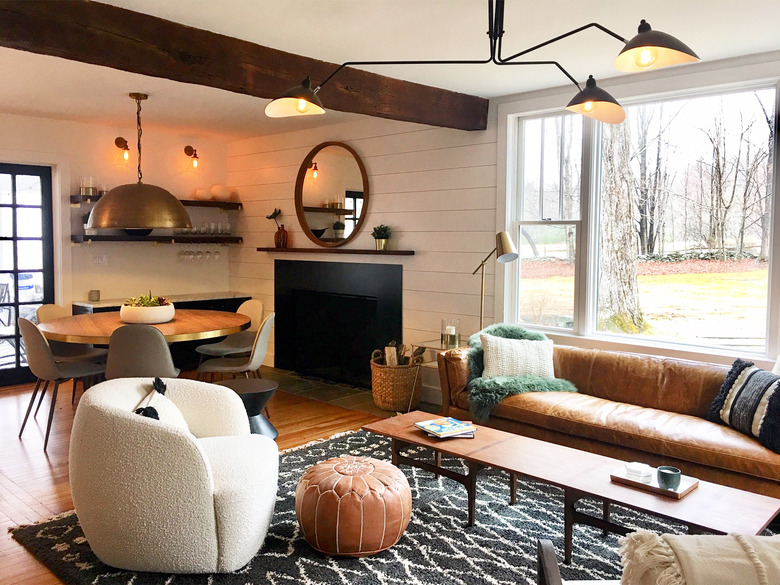 rustic living room lighting idea with chandelier and shiplap with wood beams