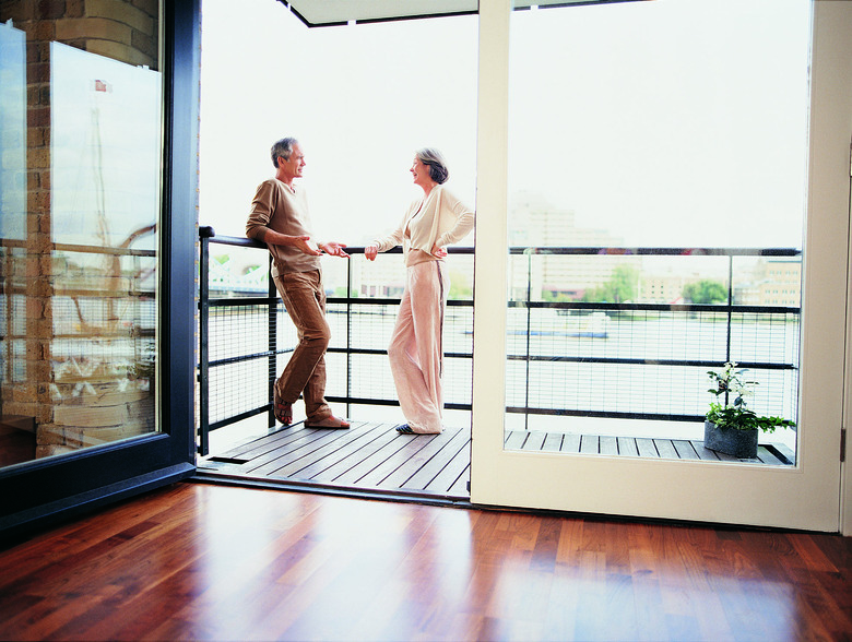 Mature Couple Talking on the Balcony of Their Apartment