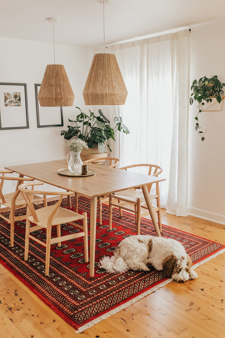 Scandinavian boho dining room with rattan pendants and Persian rug