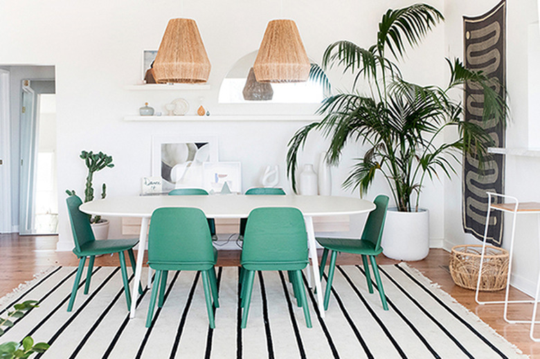 white Scandinavian boho dining room with green chairs