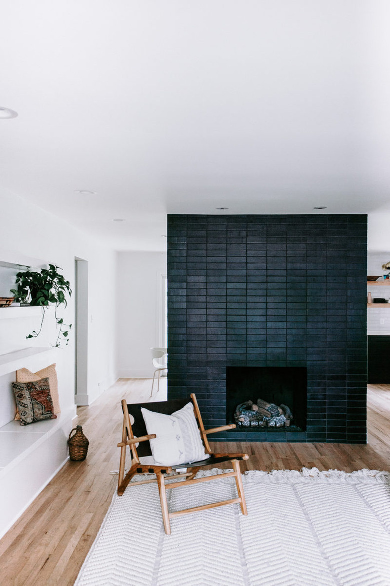 Scandinavian fireplace idea with black brick tile