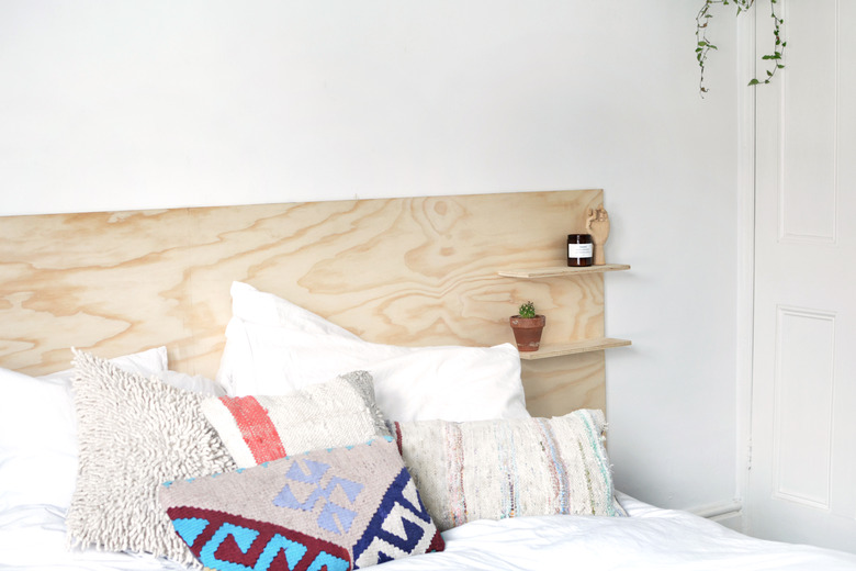 Scandinavian headboard with shelving made of plywood