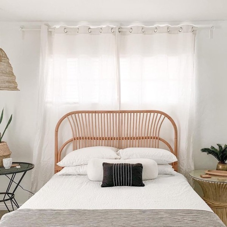 rattan Scandinavian headboard in neutral bedroom with woven pendant