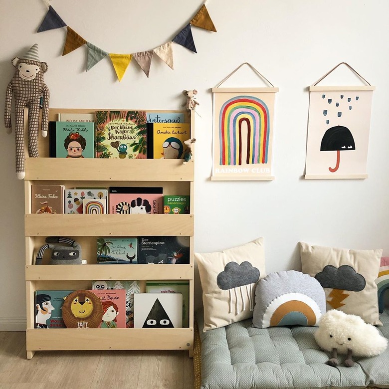 Scandinavian kids bedroom idea with floor cushion reading area