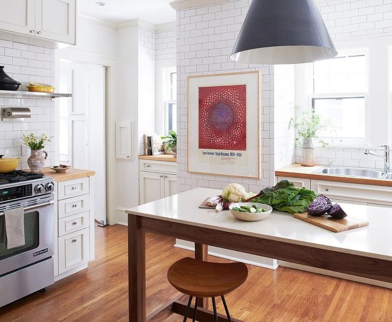 scandinavian kitchen with subway tile, large art, and pendant lamp