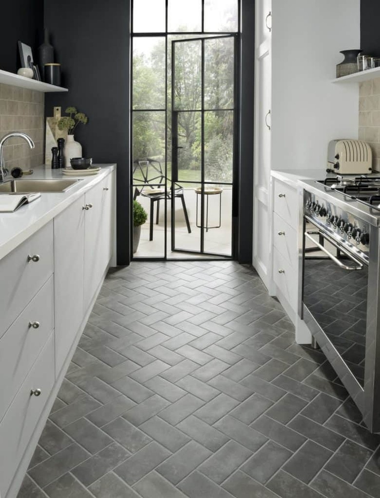 moody scandinavian kitchen with dark floor tiles