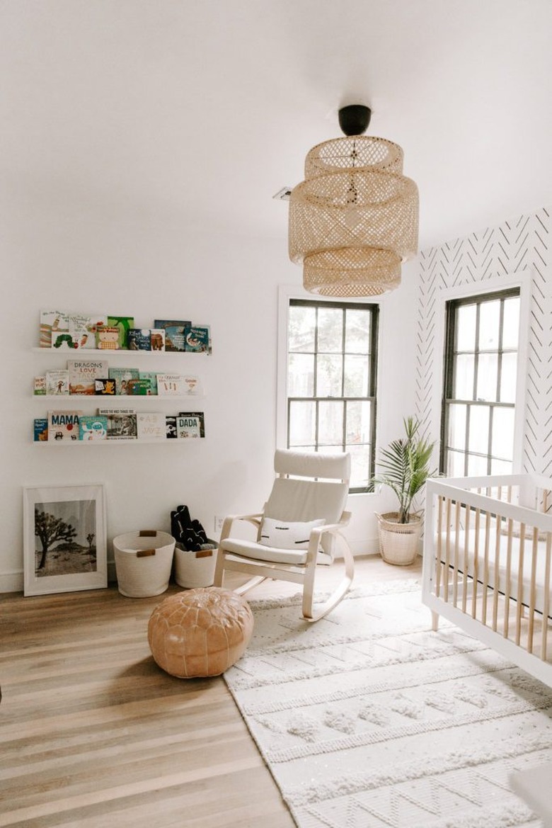 Scandinavian nursery idea with IKEA pendant and open shelving on walls with wallpaper accent wall