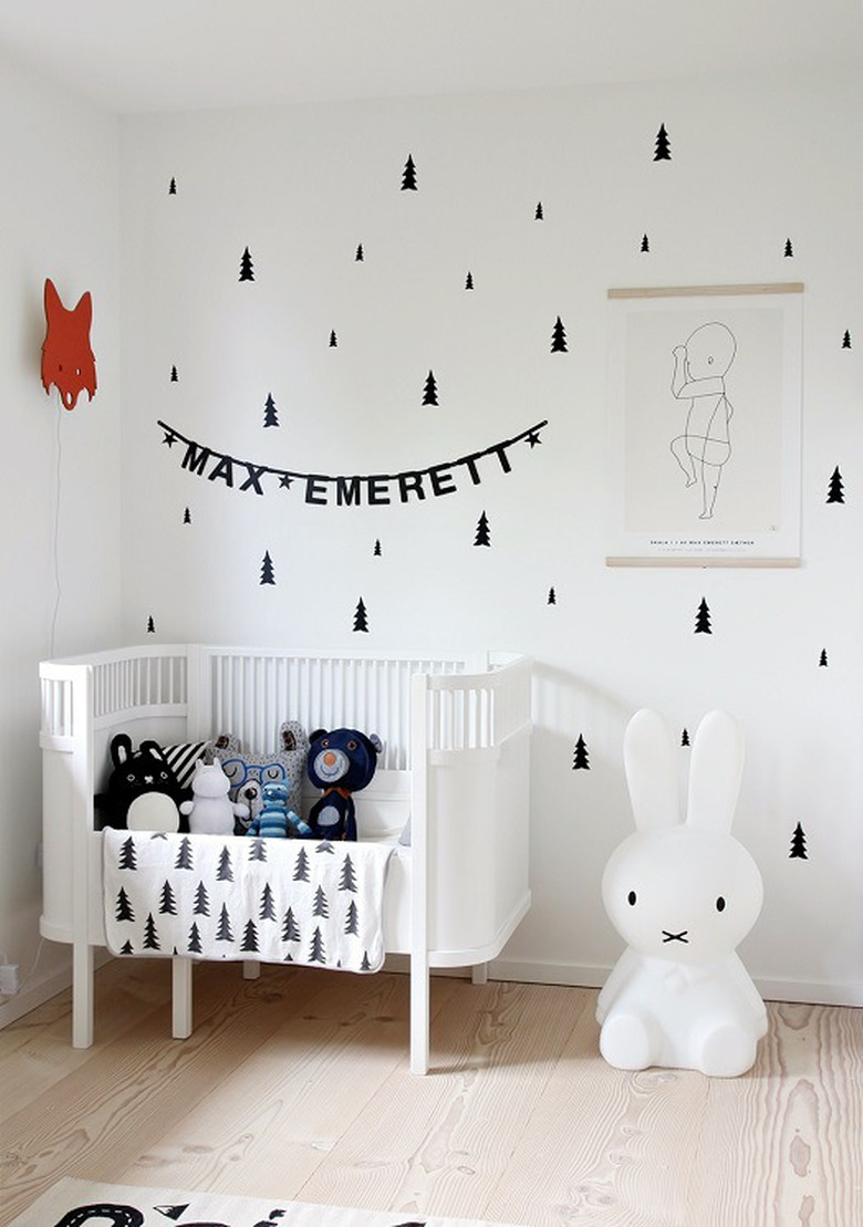 Scandinavian nursery idea with black-and-white tree pattern