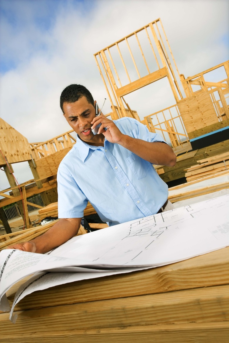 Couple with plans at construction site