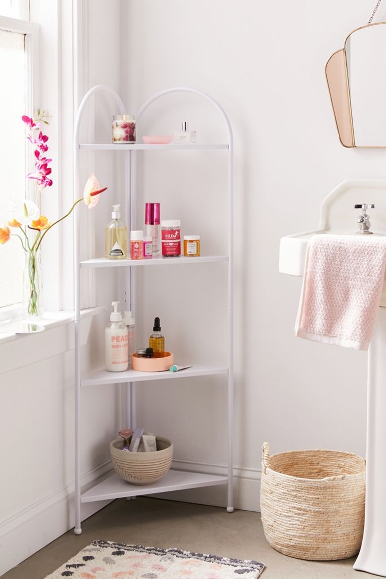 Shabby Chic Bathroom Storage in Corner bathroom shelf unit with lotions, basket, flowers, towel, sink, mirror.