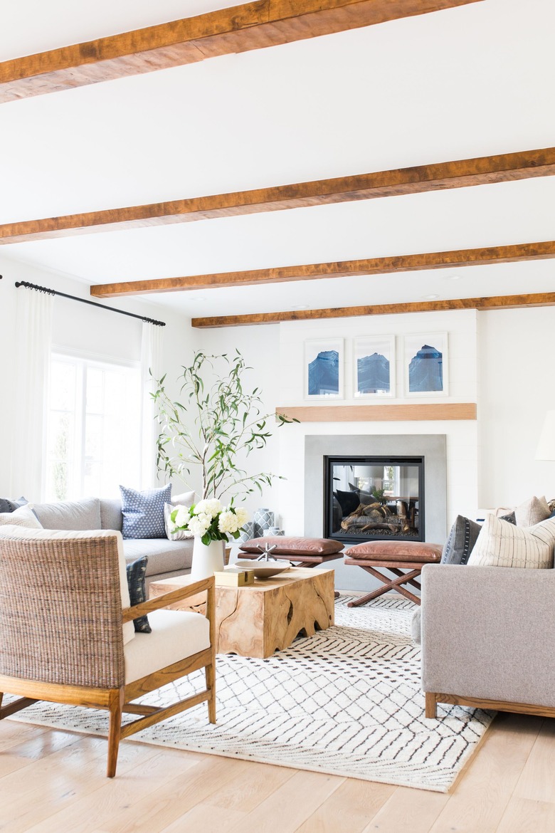 Living room with exposed wood beams and accent benches and wood block coffee table