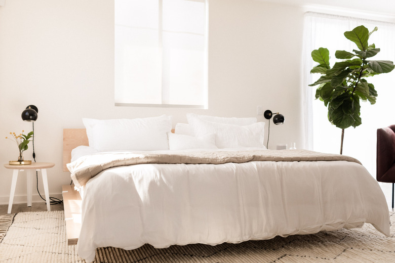 hunker house bedroom with modern side tables and black sconces