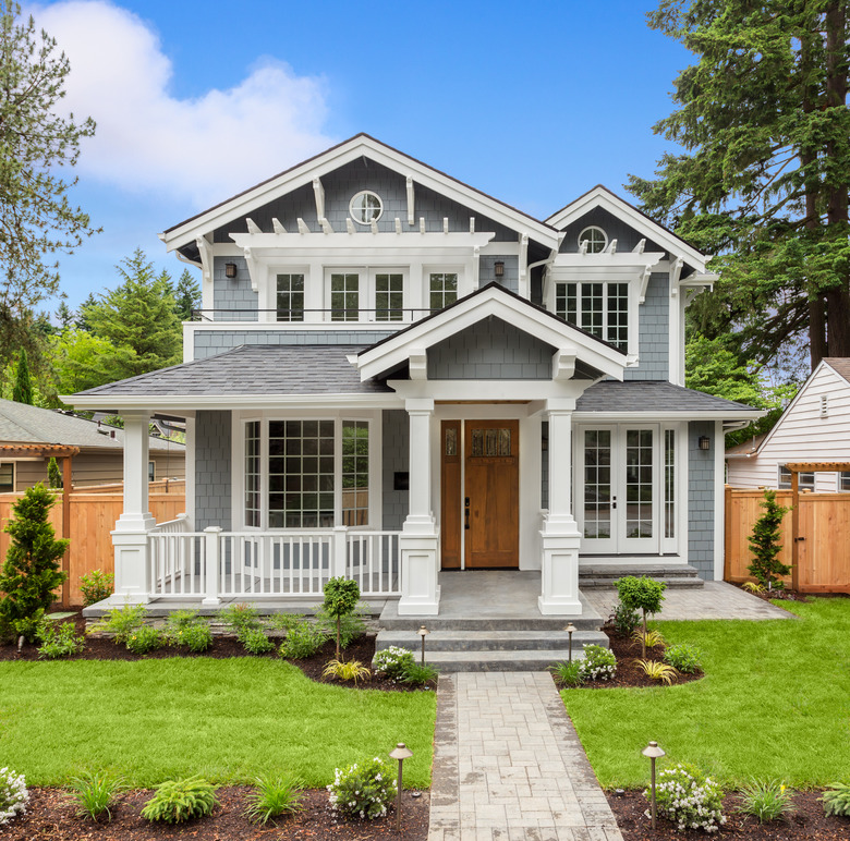 Beautiful Luxury Home Exterior with Green Grass and Landscaped yard