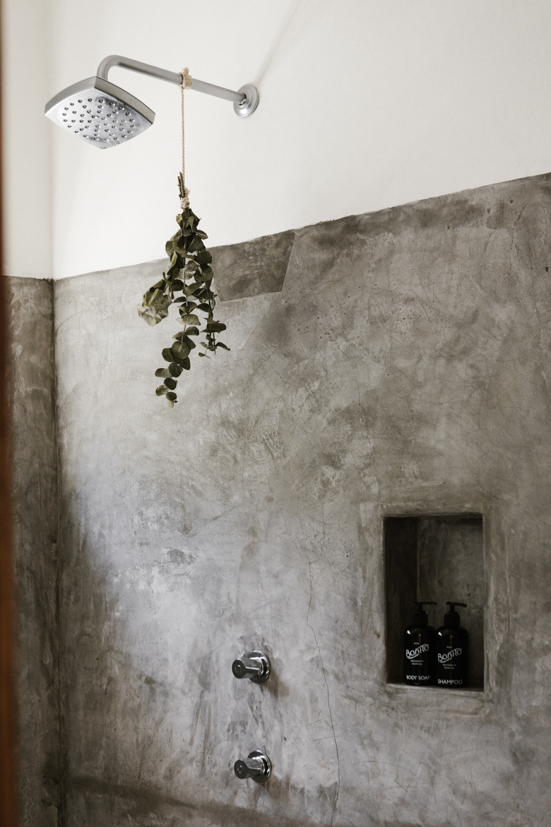 close up of shower spout with eucalyptus hanging