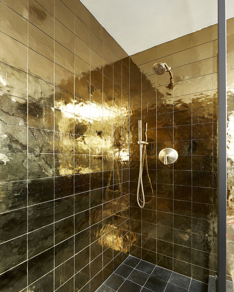 square gold shower tile ideas with gold shower head and glass doors