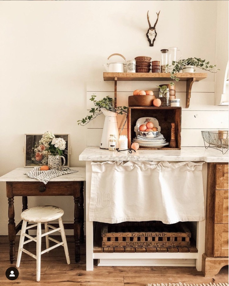 Farmhouse kitchen with shiplap backsplash and a half curtain hanging under the counter.