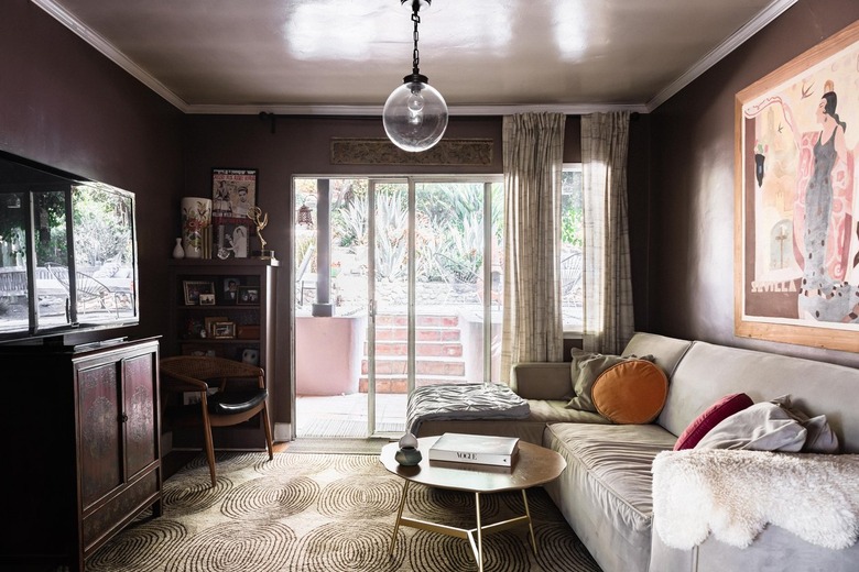 A purple living room with sliding glass doors that have insulating curtains hung up