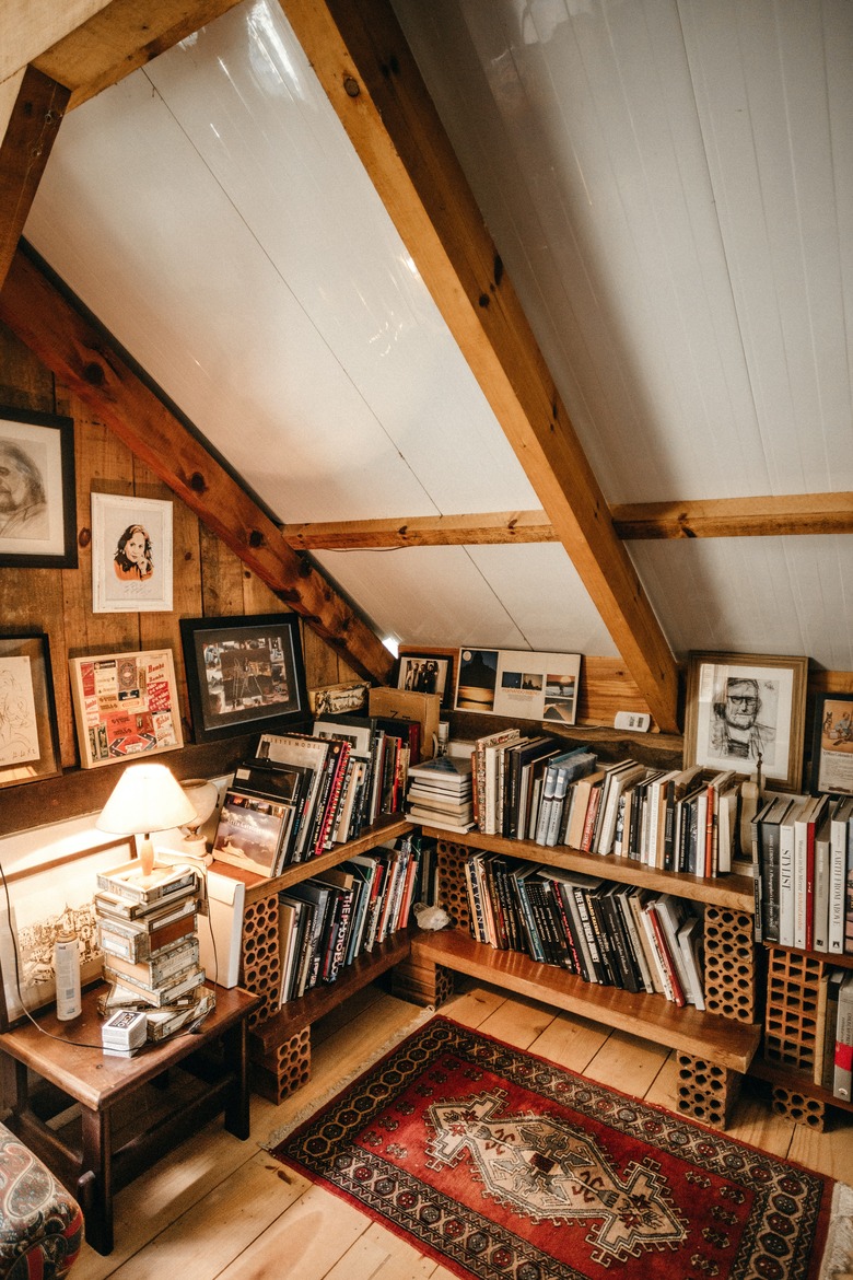 Rustic wooden small attic ideas for space converted into a book den.